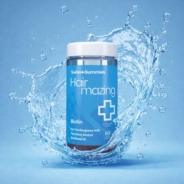 Swiss Gummies Hair mazing Biotin supplement jar with water splash on a blue background